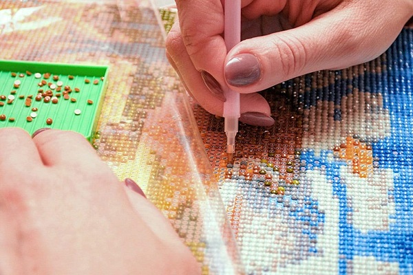 applying the diamond beads to the canvas 